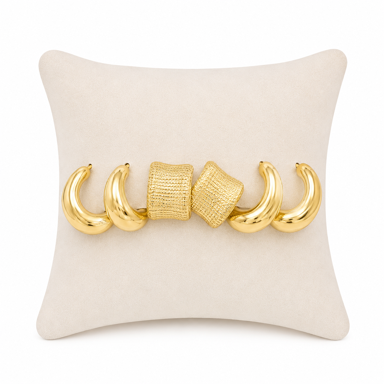 Set de aretes dorados con diseños curvos y textura geométrica.