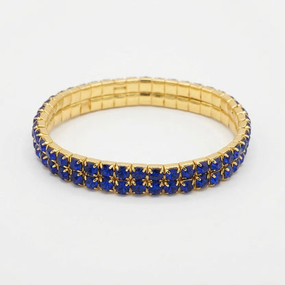 Pulsera Elástica con Cristales Azules y Color Dorado.