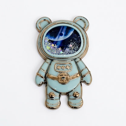 Soporte para celular de diseño astronauta con arena movediza y estrellas brillantes.