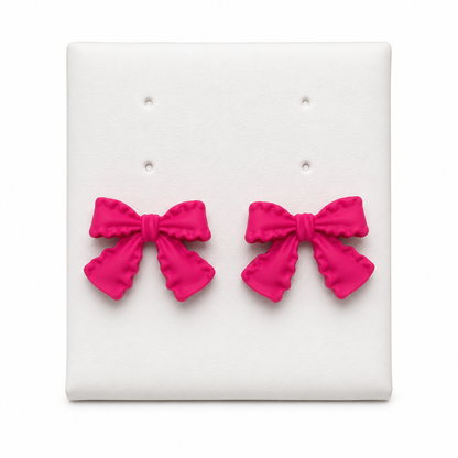 Aretes de lazo color fucsia para mujer.