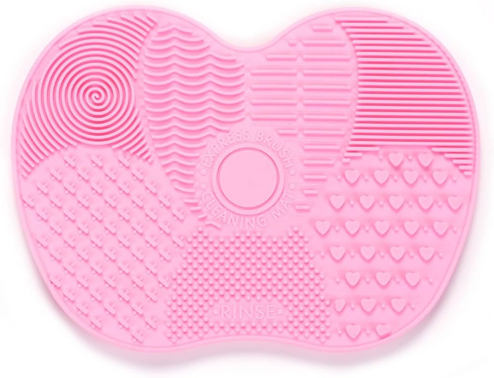 Alfombrilla de limpieza de brochas de maquillaje de silicona rosa.