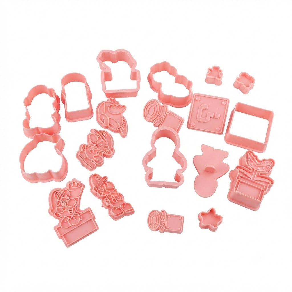 Kit contiene cortadores de galletas de plástico rosa con formas de personajes de Mario Bros y elementos del juego.