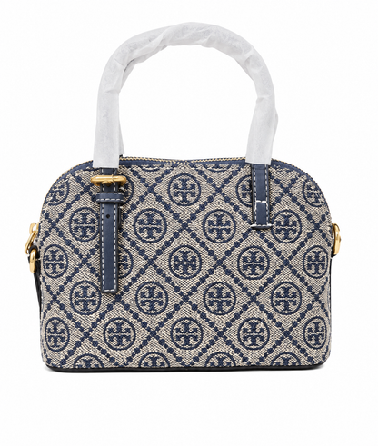 Bolso de mano pequeño con estampado geométrico, asas dobles y herrajes metálicos dorados.