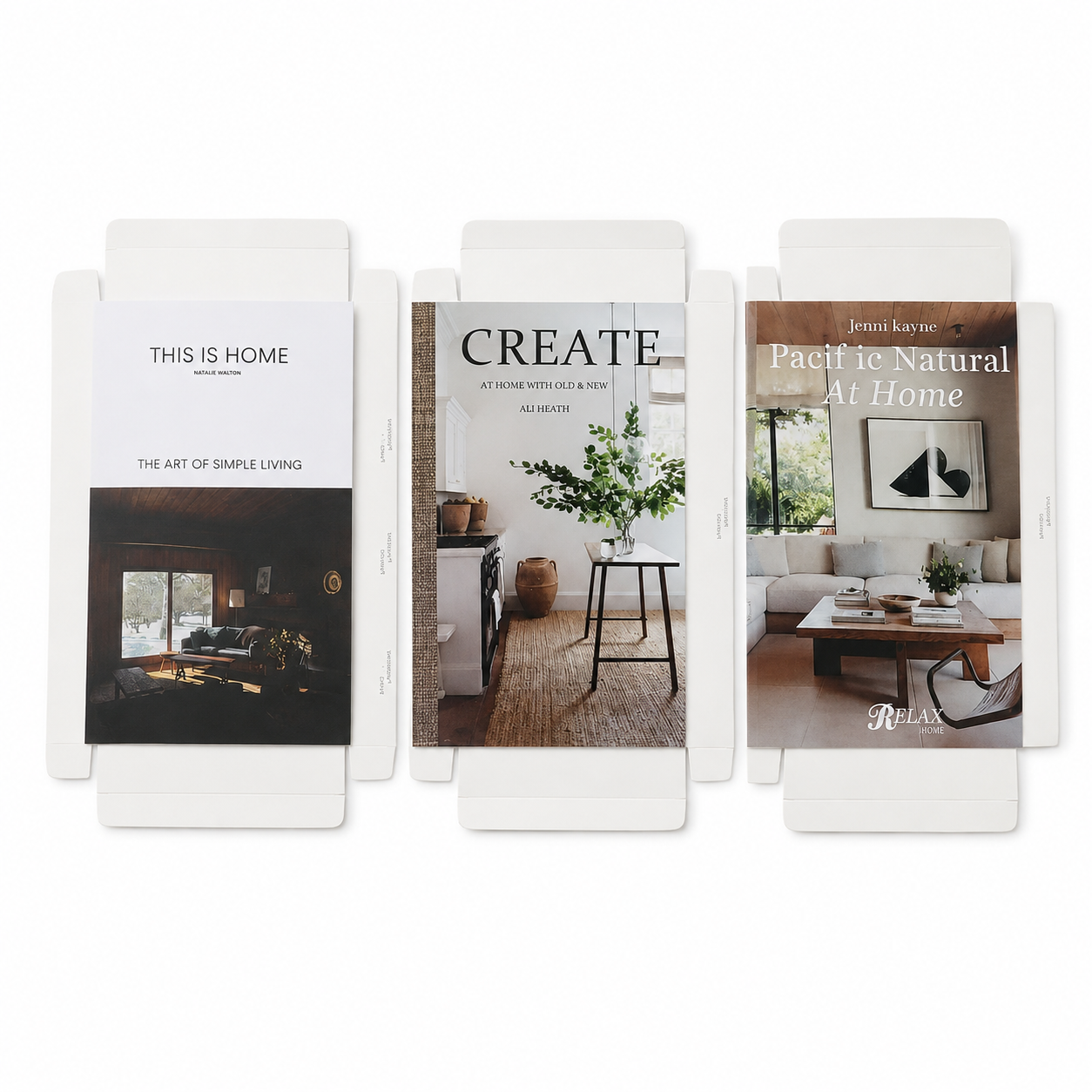 Conjunto de tres libros decorativos de cartón con diseños de interiores.