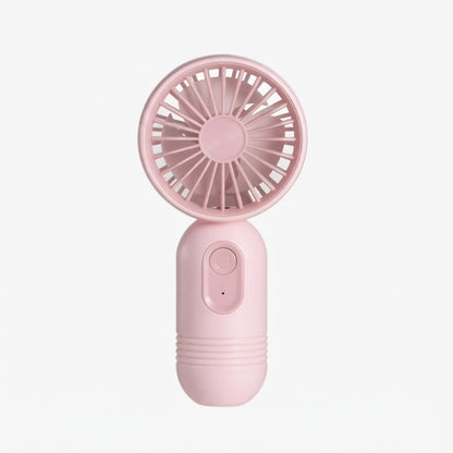 Mini ventilador portátil de mano de color rosa.