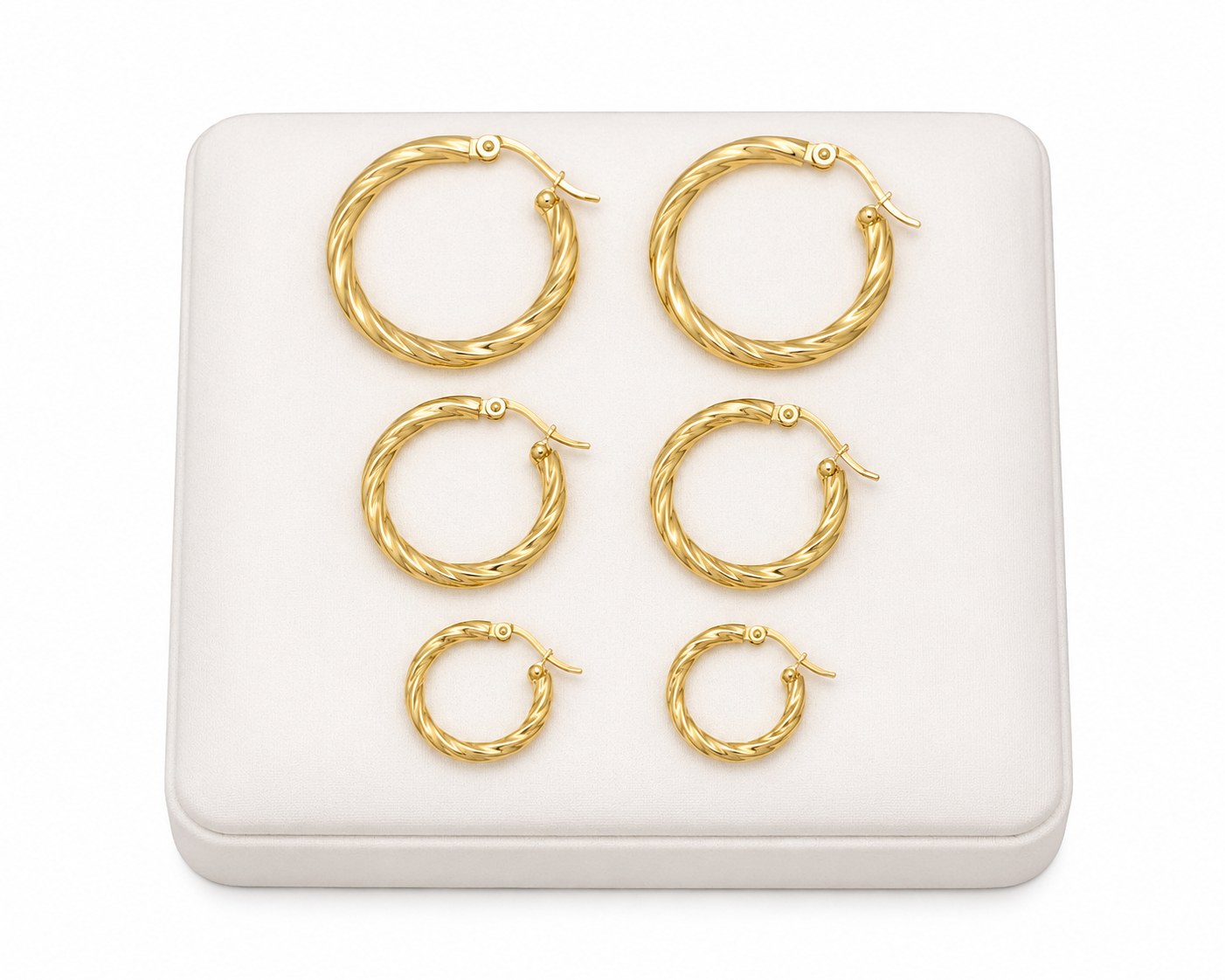 Juego de 3 pares de aretes de aro dorados con diseño trenzado en tamaños graduados.