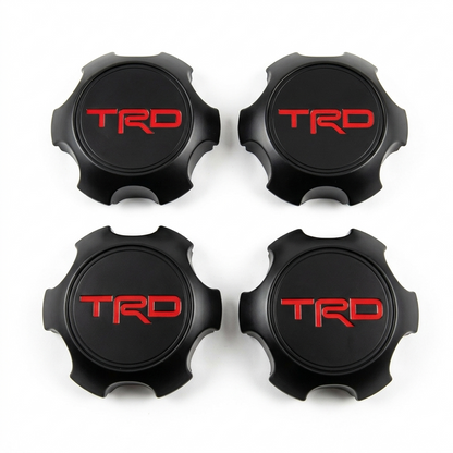 Set de tapas central de ruedas en acabado negro mate y logotipo TRD rojo, compatible con modelos Tacoma, 4Runner y FJ Cruiser.