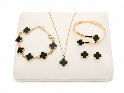 Conjunto de joyería con collar, pulsera, brazalete y aretes de diseño floral en color negro.