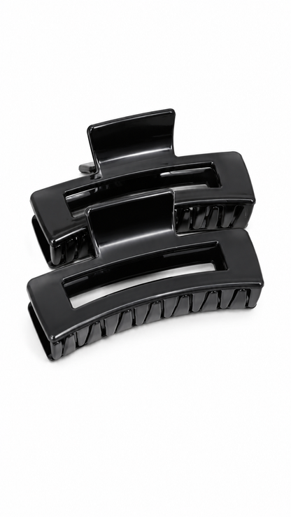 Set de pinzas grandes negras para el cabello con diseño rectangular.