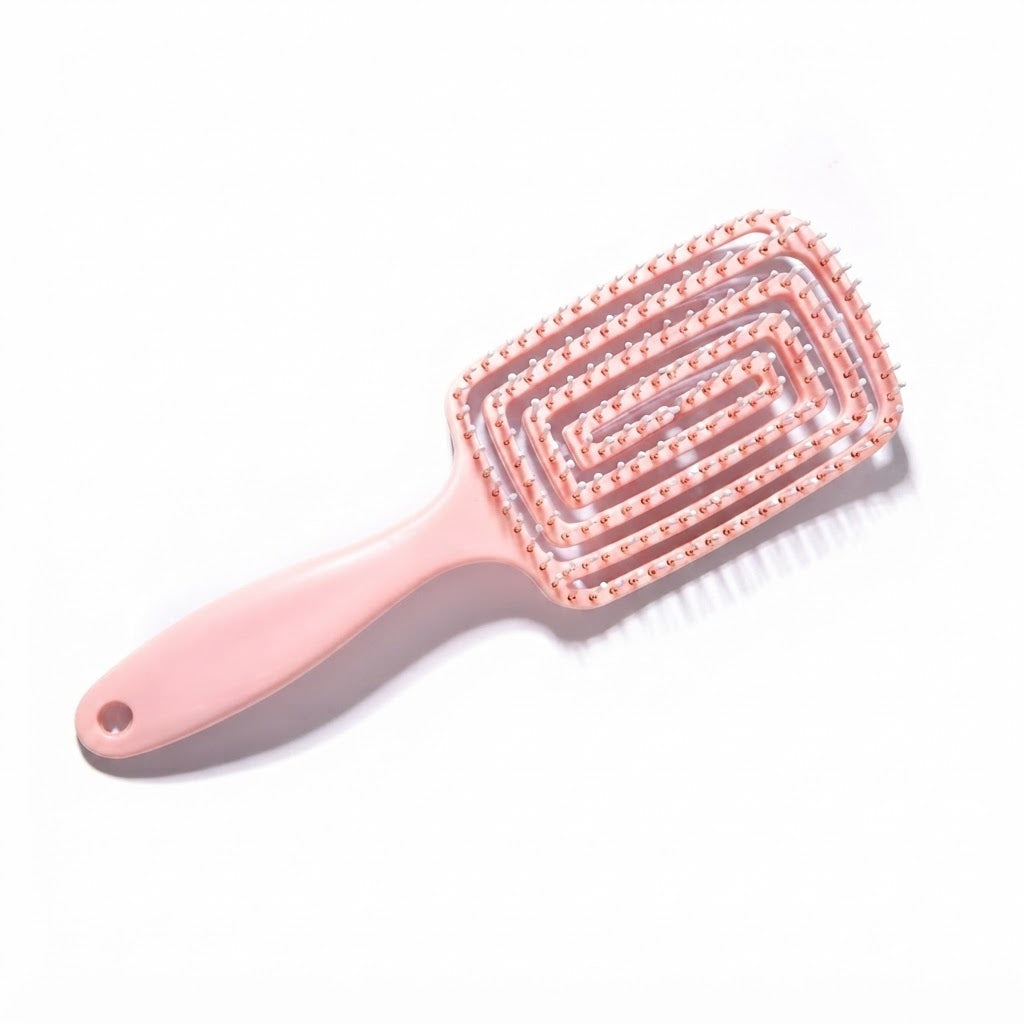 Cepillo desenredante rosa cuenta con un diseño ventilado de espiral flexible.