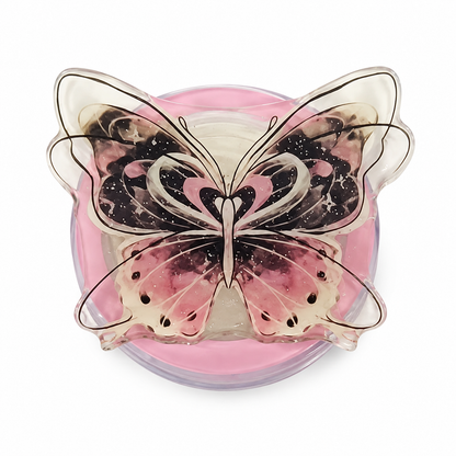 Soporte plegable para celular con mariposa tridimensional en tonos rosa y negro.