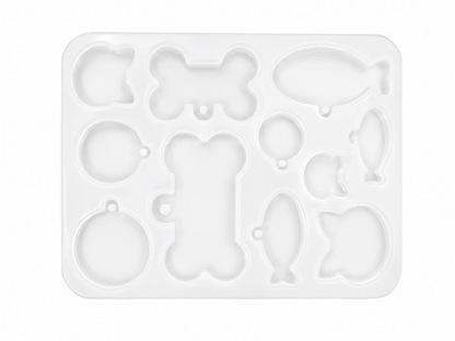 Molde para manualidades con diseños de hueso, pez, globo, manzana y gato en color blanco.