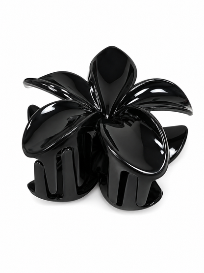 Pinza para cabello con diseño de flor color negro brillante.