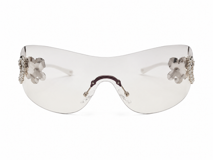 Gafas de sol tipo visor con diseño floral transparente.