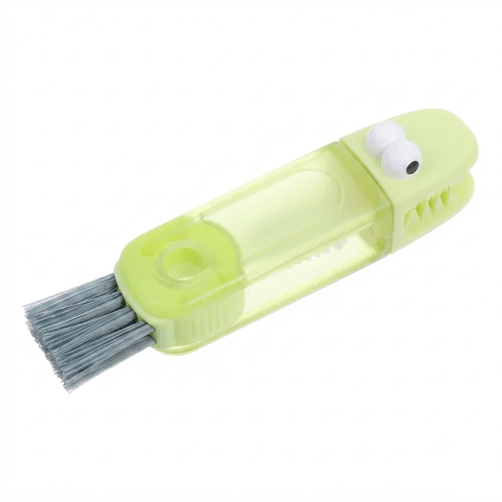 Cepillo de limpieza 3 en 1 diseñado con una forma de cocodrilo verde que incluye cepillos intercambiables.