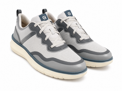 Zapatos deportivos gris y blanco con paneles de malla y suela acolchada, talla 8.5.