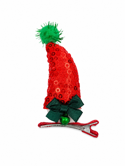 Pinza para el cabello navideño con sombrero de Santa Claus y detalle de lentejuelas.