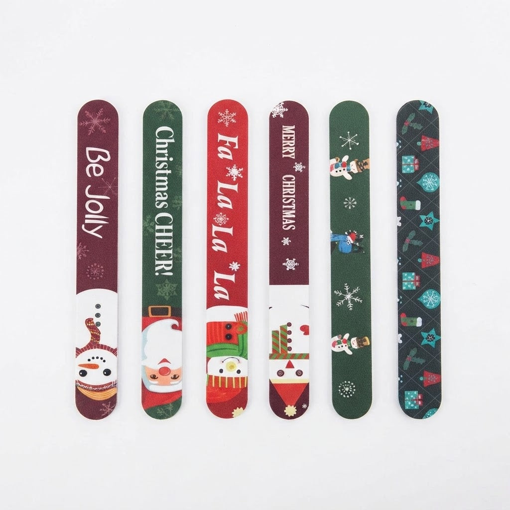 Juego de limas de uñas con diseños y frases navideñas.